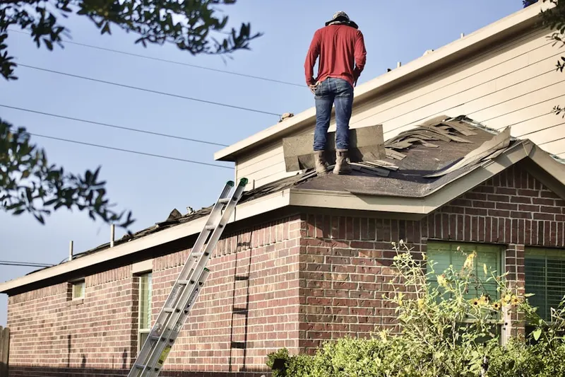 Professional roofer working on a residential roof in Von Ormy